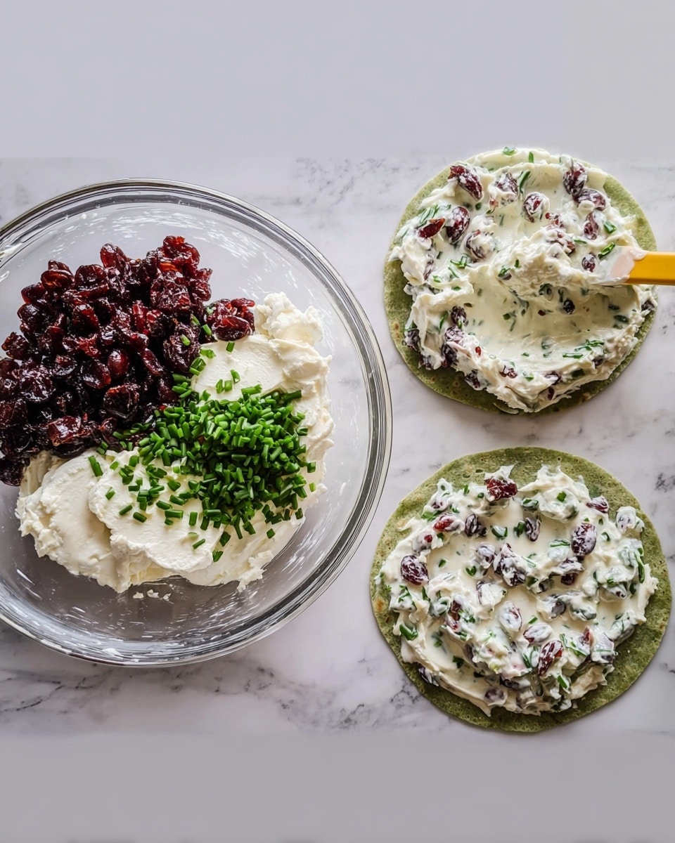 The first image shows a clear glass bowl with three layers inside: a large amount of dark red dried cranberries piled on the left, a smooth, white cream cheese block on the right, and bright green chopped chives placed on top of the cream cheese. The second image shows the same bowl with all ingredients now mixed into a creamy white spread, dotted evenly with dark red dried cranberries and bits of green chives, stirred by a yellow spatula. The third image shows a green spinach tortilla laying flat on a white marbled surface, spread with an even layer of the creamy mixture with visible pieces of dried cranberries and chives throughout. photo taken with an iphone --ar 4:5 --v 7