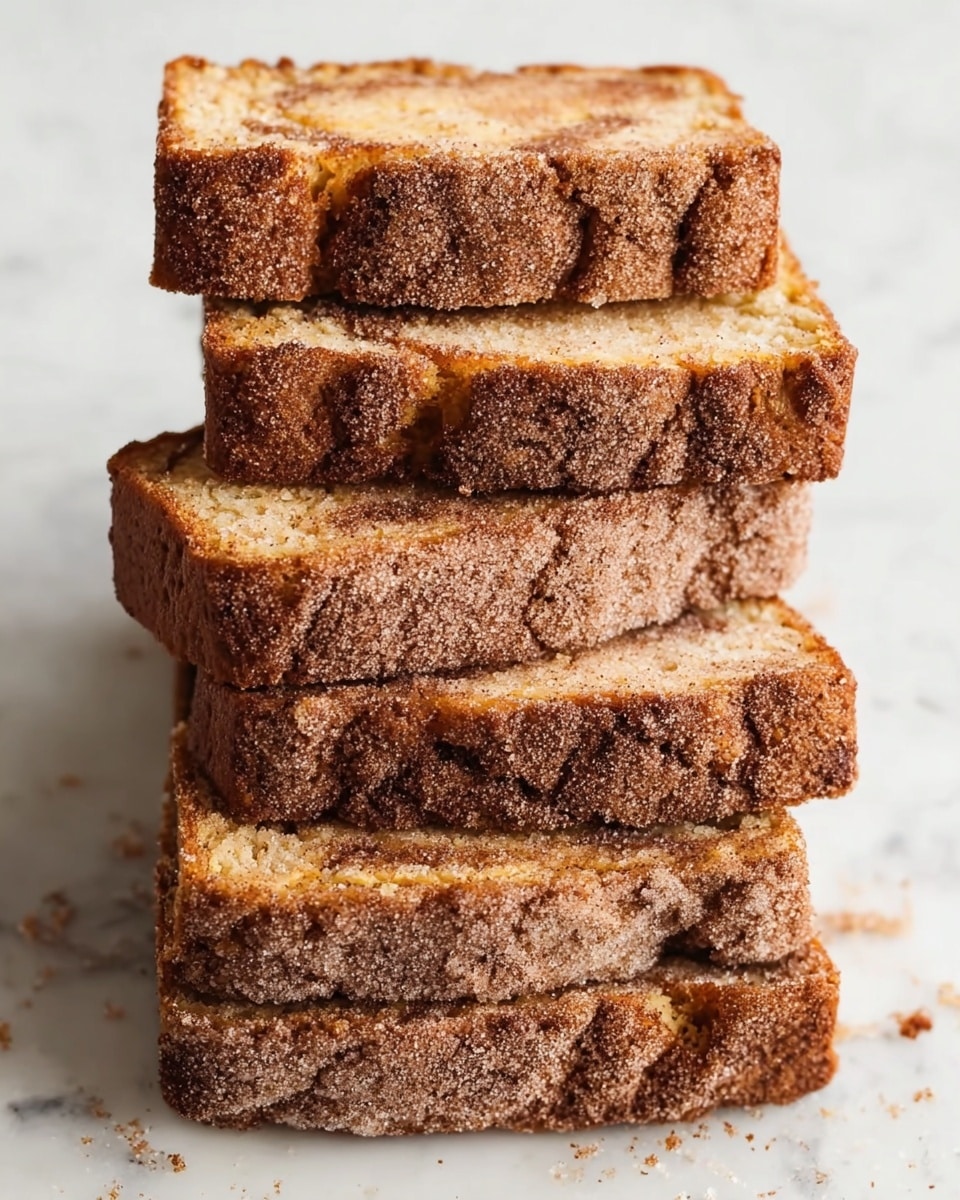 The image shows six rectangular slices of a cinnamon sugar coated cake stacked unevenly on a white marbled surface. Each slice has a golden brown color with a darker brown, cracked top surface covered in a thick layer of sugar and cinnamon, giving it a rough texture. The cake appears soft with a slightly crumbly texture, and there is a subtle marbling of cinnamon inside the layers. The edges of the slices are slightly darker, showing a baked crust. photo taken with an iphone --ar 4:5 --v 7