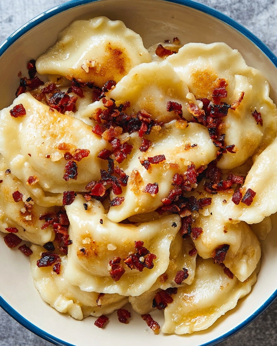 A white dish full of light golden pierogies, each one slightly rounded and soft with edges that are pinched and crimped. The pierogies are topped and mixed with small pieces of crispy, dark brown bacon bits that add texture and contrast. The pierogies have a slight shine from melted butter or oil, with some parts lightly browned, giving a warm and inviting look. The dish rests on a white marbled surface. photo taken with an iphone --ar 4:5 --v 7