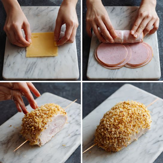 The image shows a step-by-step process of making a stuffed chicken fillet. The first layer shows a woman's hands folding a slice of pale yellow cheese and two round ham slices, one slice being light pink and the other pale pink, on a white marbled surface. The second layer shows a woman's hand holding the folded ham slices above the same surface. The third layer shows a woman's hands rolling the ham and cheese together inside a pale pink chicken fillet. The fourth layer shows the chicken fillet wrapped around the filling, secured with small wooden toothpicks, resting on the white marbled surface. The last layer shows the chicken fillet coated with a golden breadcrumb layer, giving it a rough, crunchy texture, placed on a dark surface. photo taken with an iphone --ar 4:5 --v 7