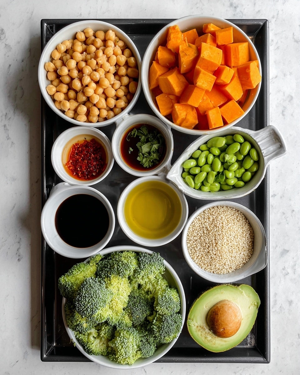 The image shows a black tray on a white marbled surface holding ten white bowls and small containers of different ingredients arranged neatly. From top left, there is a bowl full of chickpeas, next to it a bowl with bright orange cubed sweet potatoes, below the chickpeas a bowl of edamame beans, and below the sweet potatoes a bowl of fresh broccoli florets. In the center, there are small white containers holding light brown sauce, soy sauce, minced garlic, chili sauce, a clear yellow liquid, chopped green herbs, and a bowl of white quinoa. On the bottom right corner of the tray, there is a halved avocado with bright green flesh visible. The photo taken with an iphone --ar 4:5 --v 7