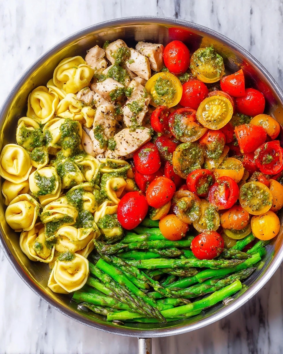 The image shows a pan with three sections of food. On the left side, there are bright green asparagus spears with red and yellow cherry tomatoes scattered on top. The top right section has light beige tortellini pasta with a light herb sauce. The bottom right section contains pieces of cooked meat mixed with more red and yellow cherry tomato halves. The pan is on a wooden surface. photo taken with an iphone --ar 4:5 --v 7