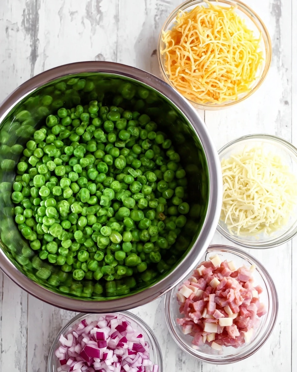 A large metal bowl at the center filled with fresh bright green peas. Around it, four small clear glass bowls are placed on a white marbled surface: one with finely chopped red onions, one with shredded yellow cheese, one with small pieces of cooked pink and white bacon, and one with shredded white cheese. The setup is neat and well-organized, showing ingredients ready to be mixed. Photo taken with an iphone --ar 4:5 --v 7
