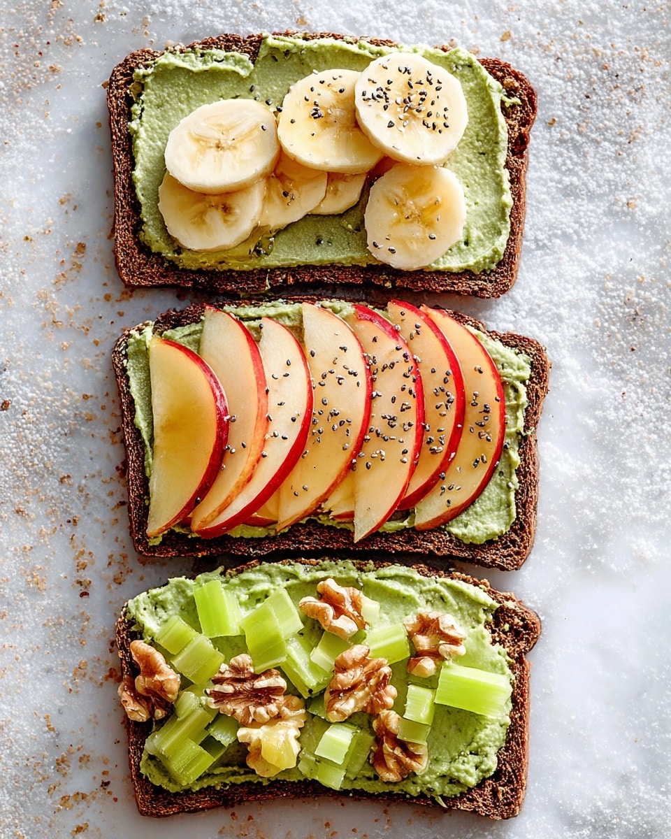 Three slices of dark brown whole grain toast are placed on a white marbled surface. Each toast slice is spread with a thick layer of smooth, green pesto-like spread. The top slice is topped with three banana slices drizzled lightly with honey. The middle slice has thin, neatly arranged red apple slices sprinkled with small black chia seeds. The bottom slice is garnished with light green celery slices and small chunks of walnuts. The textures contrast between soft fruit, crunchy toast, and creamy spread, creating a fresh and natural look. Photo taken with an iphone --ar 4:5 --v 7