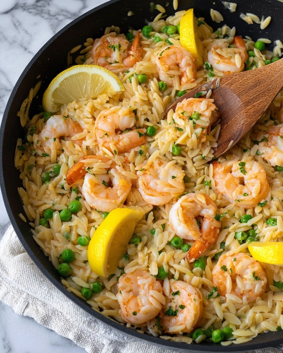 A black pan sits on a white marbled surface, filled with a cooked dish made of three main layers: the bottom layer is orzo rice that is light golden and soft, mixed throughout with small bright green peas. Scattered evenly on top are plump, pink shrimp with a slight shine, giving a fresh cooked look. Mixed in and visible among the shrimp and rice are small bits of translucent cooked onion, adding texture. On top of this mix, four lemon wedges with a yellow peel and pale yellow inside are placed at different spots, adding color contrast. A wooden spoon rests inside the pan on the right side, slightly lifting some of the orzo dish. In the background, a bag of shredded cheese and a sliced lemon half faintly appear. photo taken with an iphone --ar 4:5 --v 7