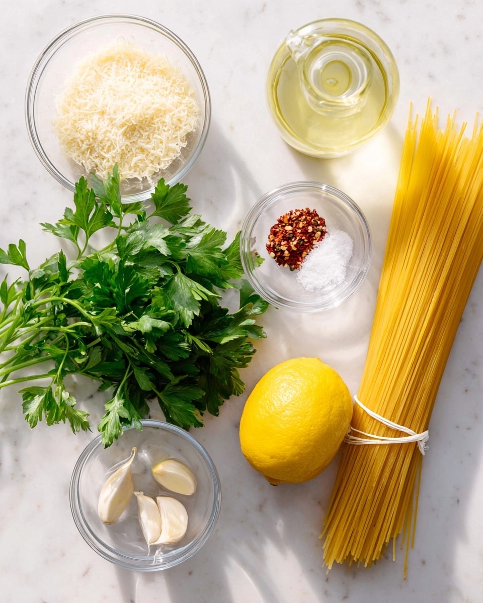 The image shows uncooked spaghetti tied together with a white string on the right side, next to a whole yellow lemon placed near the bottom center. Above the lemon is a small clear bowl filled with coarse salt, and a little higher to the right is a clear bottle with a light yellow liquid, likely olive oil. In the center, there is a bunch of fresh green parsley with detailed leaves spread out. On the left, three clear bowls hold different ingredients: the bottom one is filled with fine grated cheese, the middle one has three garlic cloves, and the top one contains small red chili flakes. All items are placed on a clean white marbled surface with soft natural light. photo taken with an iphone --ar 4:5 --v 7